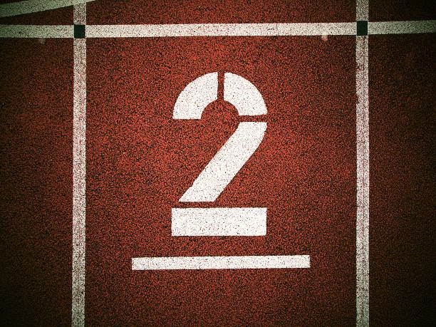 istock Number two. Big white track number on red rubber racetrack. 480789346