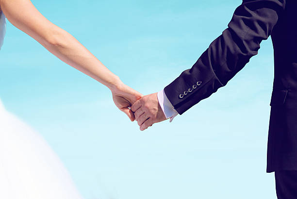 istock Beautiful wedding couple, bride and groom holding hands looking 480793458