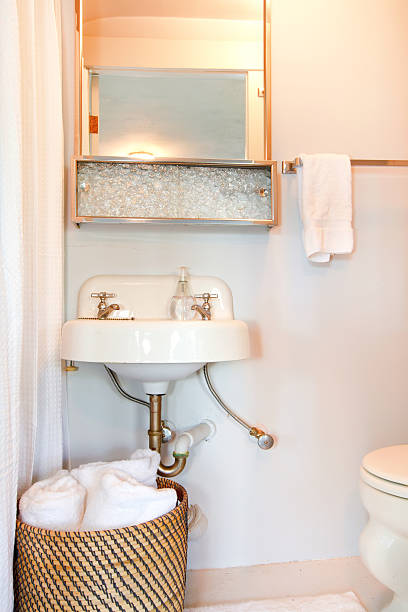 istock Small blue bathroom with antique sink and white towels. 480793525