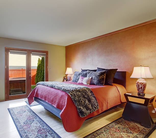 istock Beautiful master bedroom with red bedding and beige walls. 480794144