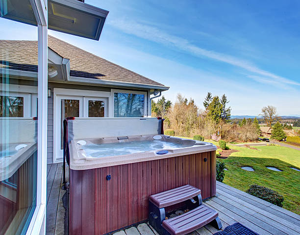 istock Traditional back deck with tall windows, and hot tub tub. 480794310