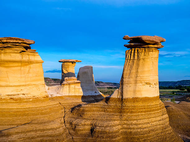 Hoodoos, Drumheller Hoodoos bathed in the warm light of a summer sunset at Drumheller Alberta Canada. drumheller valley stock pictures, royalty-free photos & images