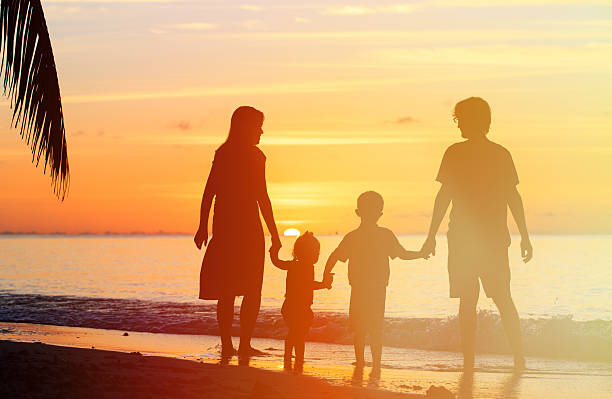 istock happy family with two kids on sunset beach 480797116