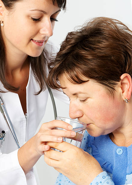 istock Senior patient woman drinks water 480798078