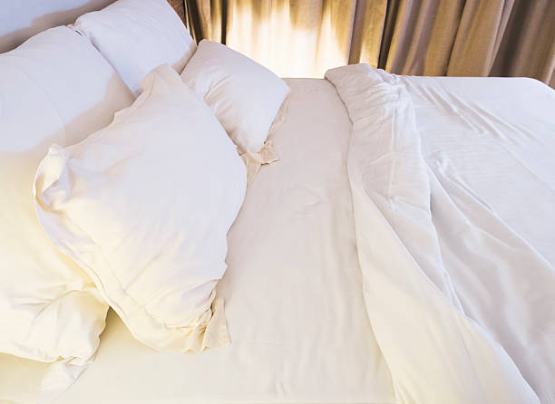 istock Bed mattress and pillows messed up in bedroom with lighting 480802154