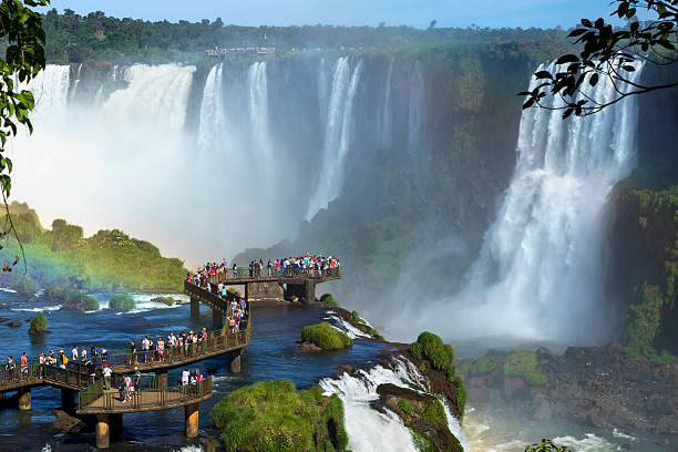 Tourists at Iguazu Falls, Foz do Iguacu, Brazil Tourists at Iguazu Falls, one of the world's great natural wonders, near the border of Argentina and Brazil. misiones province stock pictures, royalty-free photos & images