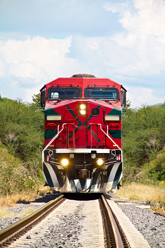 Houston, United States - February 27, 2023:  A Burlington Northern and Santa Fe (BNSF) Railway train traveling toward downtown Houston on a late winter afternoon.