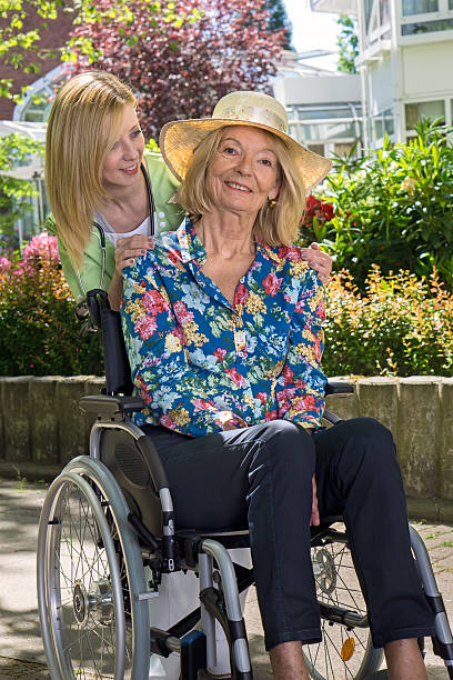 istock Nurse with Senior Woman Outdoors in Garden. 480803206