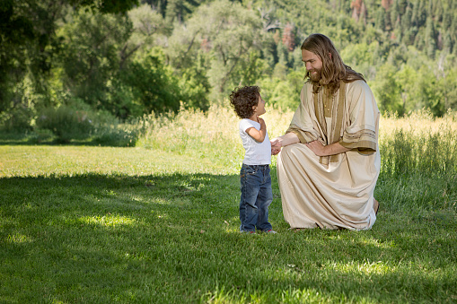 Jesus kneeling with child