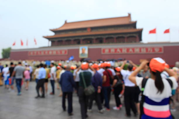 Beijing, China - 1st October 2013: Crowds of tourists during the Golden Week national holiday at the Gate of Divine Might of the Forbidden City, the iconic UNESCO World Heritage Site in the heart of Beijing, China's vibrant capital city. Composite panoramic image created from three contemporaneous sequential photographs.