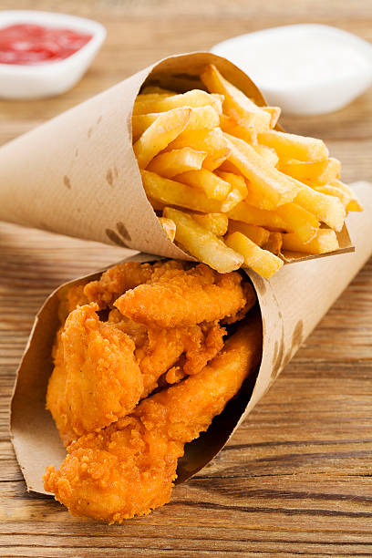 istock Nuggets and chips served in a paper bag with dips 480811716