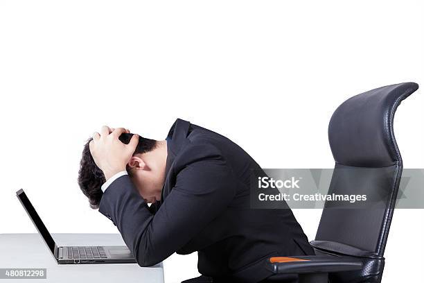 Confused Worker With Laptop On Table Stock Photo - Download Image Now - 2015, Adult, Adversity