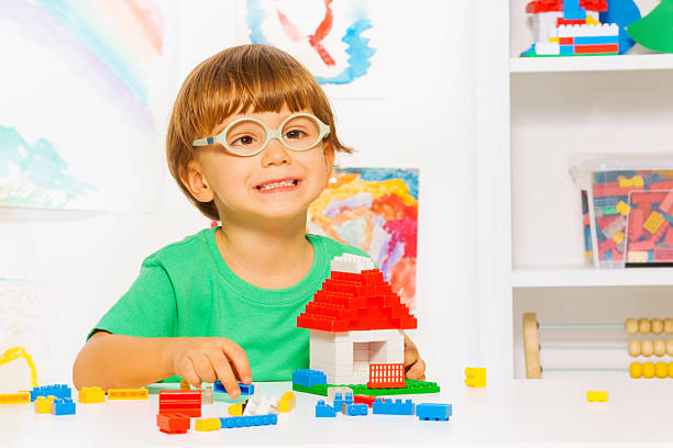 istock Smart little boy build toy plastic blocks house 480812676