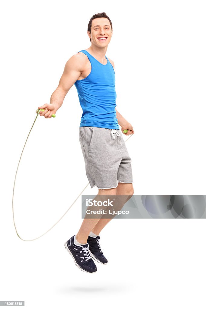 Young athlete exercising with a skipping rope Full length profile shot of a young athlete exercising with a skipping rope and looking at the camera isolated on white background Jump Rope Stock Photo