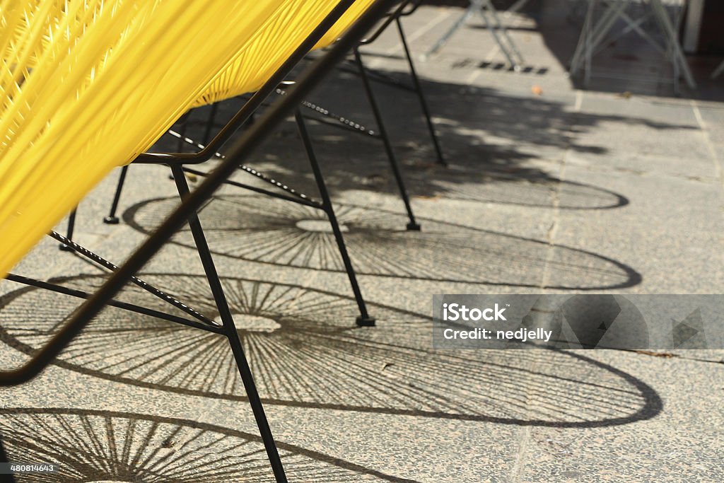 Modern outdoor chairs casting a shadow Acapulco-replica chairs casting interesting shadows Acapulco Stock Photo