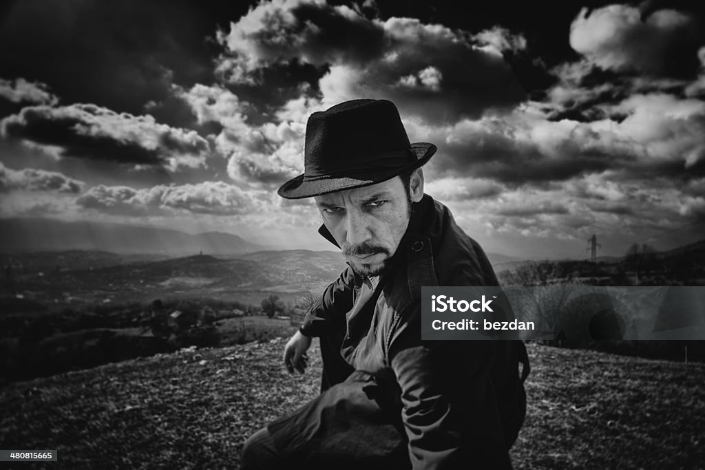 Man with black hat Black and white portrait of the main in the raincoat and with a hat 1970-1979 Stock Photo