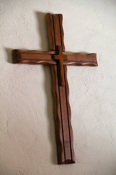 istock Handmade Wooden Cross Hanging on Plaster Wall 480816825