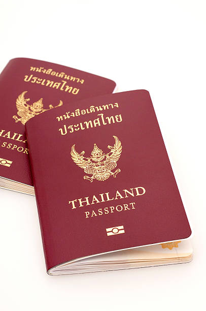 thailand-passport - customs official examining emigration and immigration document stock-fotos und bilder