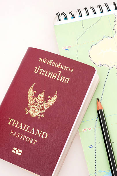 thailand-passport - customs official examining emigration and immigration document stock-fotos und bilder