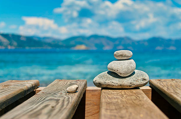 istock three pebbles stacked one upon another on wooden plates 480823446