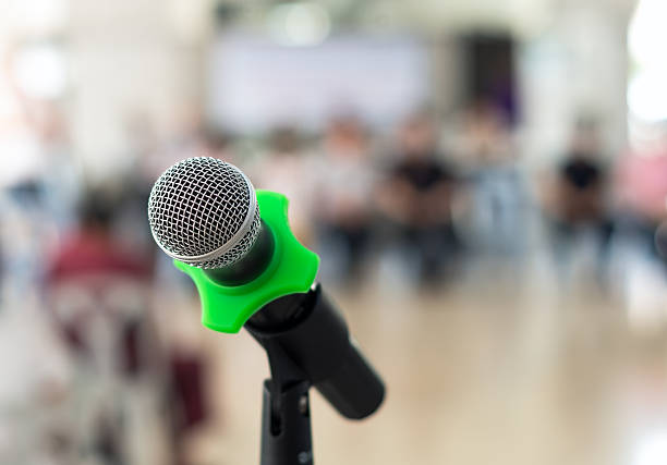 istock Close up of microphone in conference room on blurred background 480823480