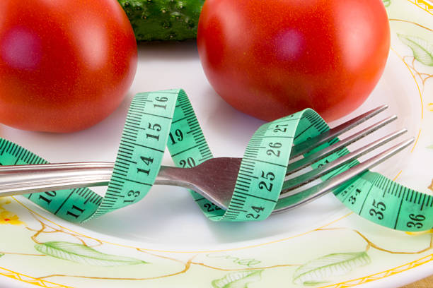 istock Cucumber and tomato with measuring 480823934