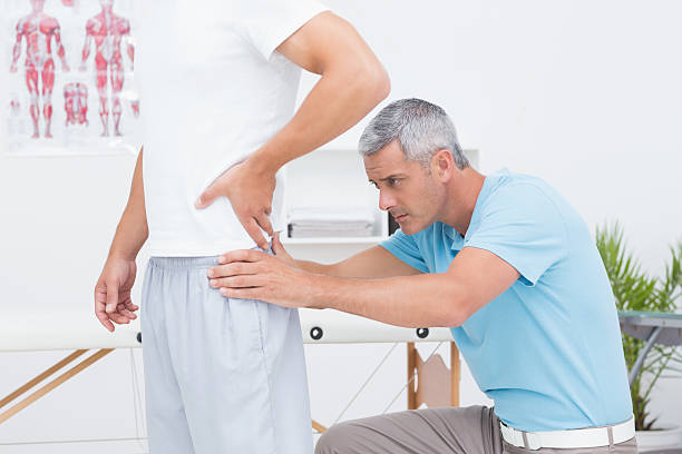 istock Doctor examining his patient back 480827440