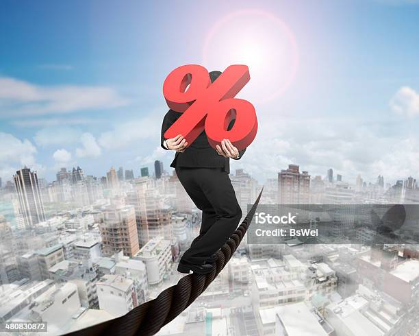 Businessman Carrying 3d Red Percentage Sign Balancing On Wire Stock Photo - Download Image Now