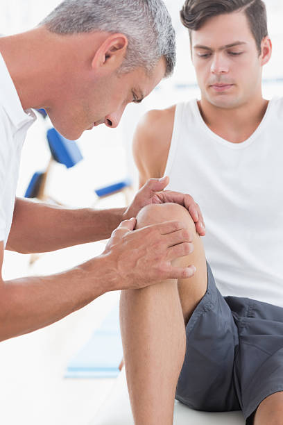 istock Doctor examining his patient knee 480830930