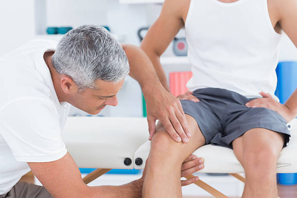 istock Doctor examining his patient knee 480831044