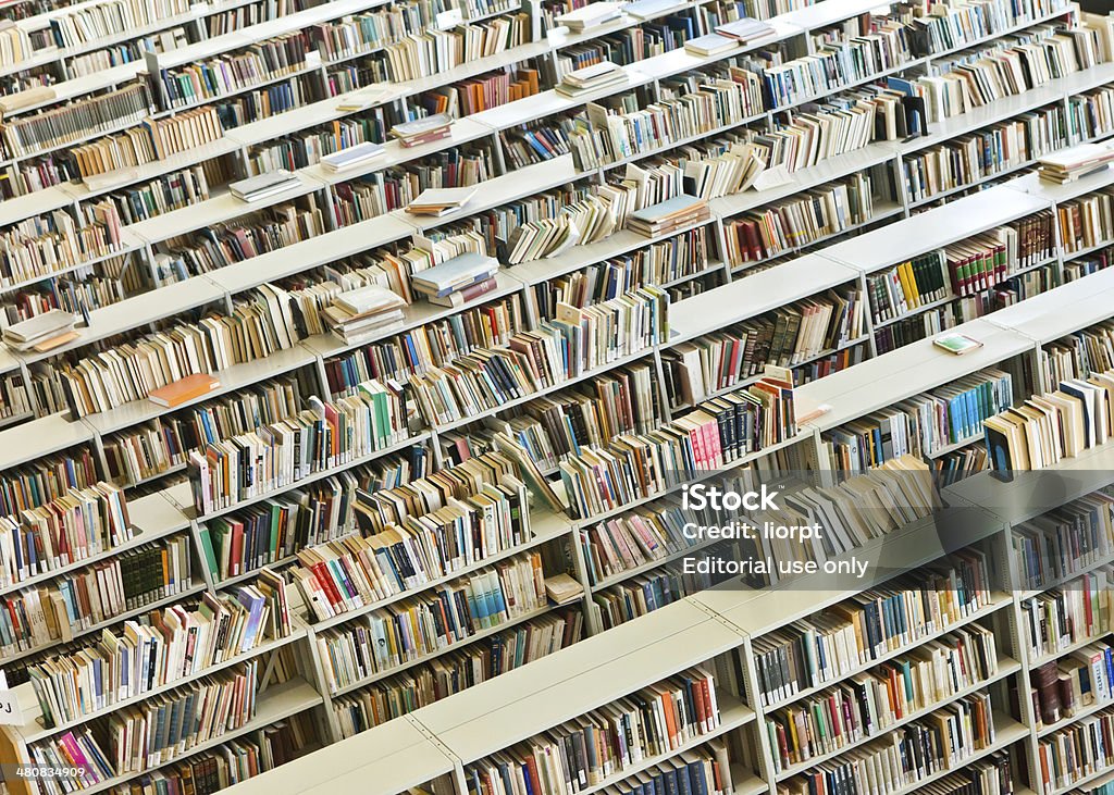 Rows of books in a public library Tel Aviv, Israel - March 23, 2014: Rows of books in a public library shot with natural daytime light. Book Stock Photo