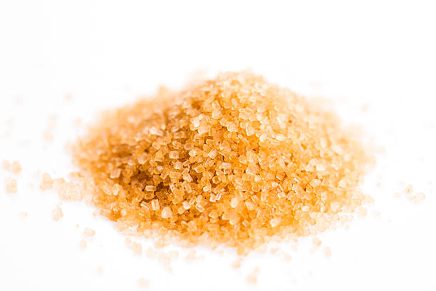 istock Crystals cane sugar heap close up isolated on white 480837092