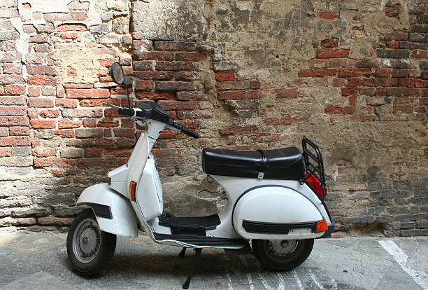 istock White scooter in front of brick wall 480837098