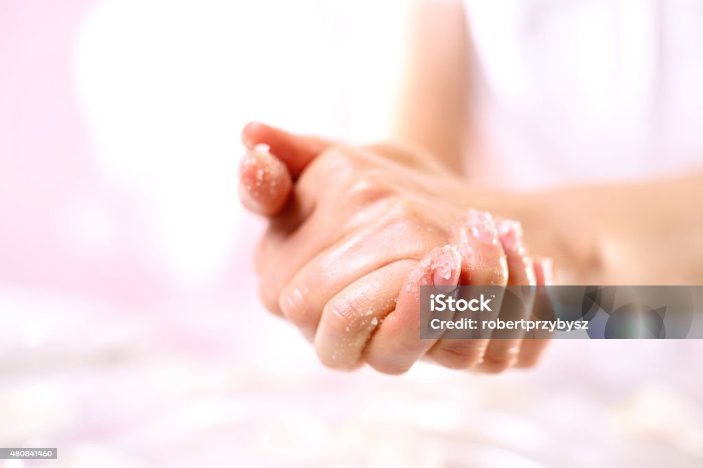Grained hand peeling The woman imposes on hand scrub cosmetic Exfoliation Stock Photo