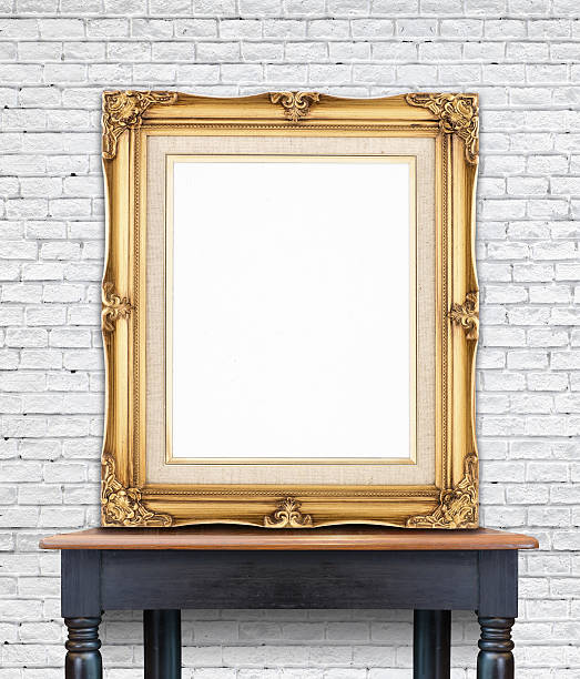 istock Blank vintage golden photo frame lean at white brick wall 480843292