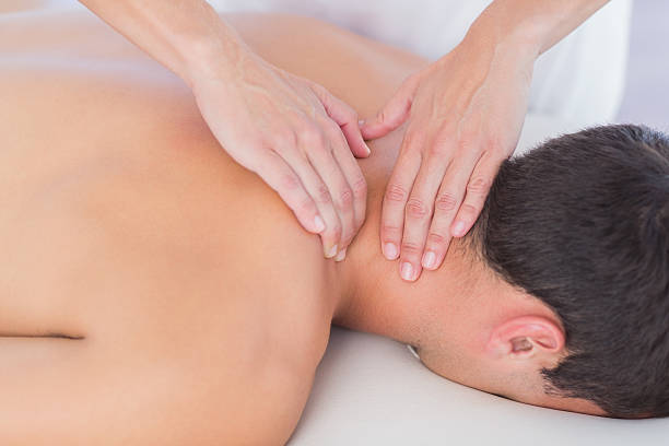 istock Physiotherapist doing neck massage to her patient 480844494