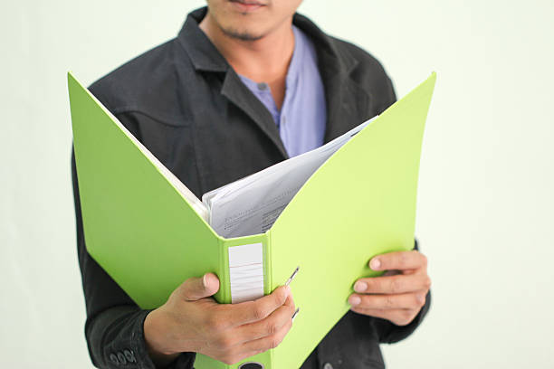istock Smart businessman wearing a suit and tie, holding a folder 480847271