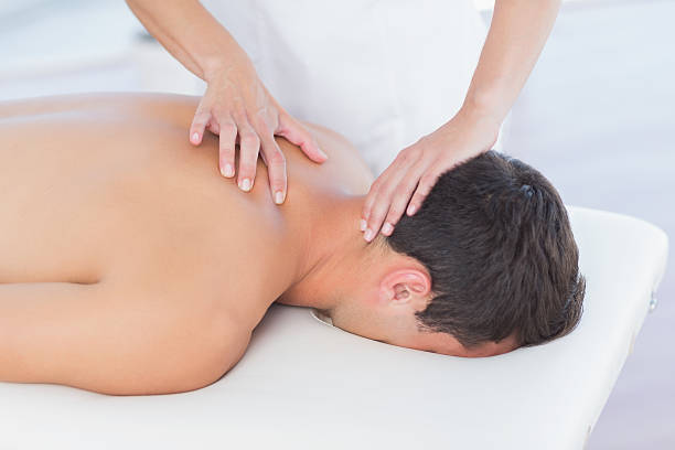 istock Physiotherapist doing neck massage to her patient 480848850