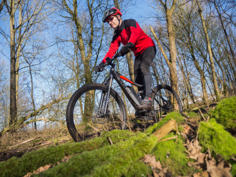 Almere, Netherlands - February 3, 2014: Mountain biker test riding a brand new  state of the art Cube electric powered mountainbike which uses a Bosch motor and provides a smooth and easy ride on rough terrain