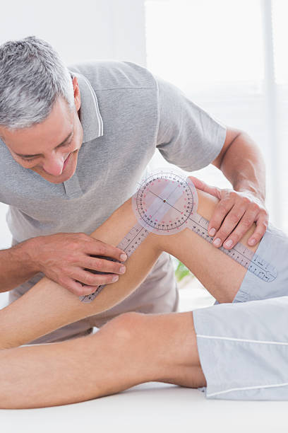istock Doctor examining man leg 480849142