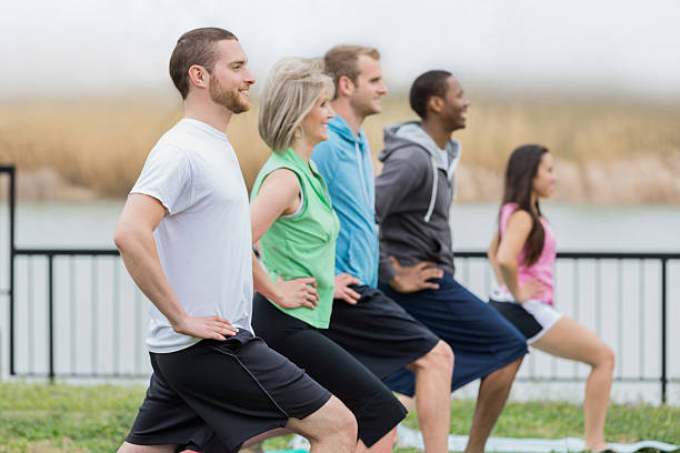 istock Diverse exercise club stretching during outdoor yoga class 480849267