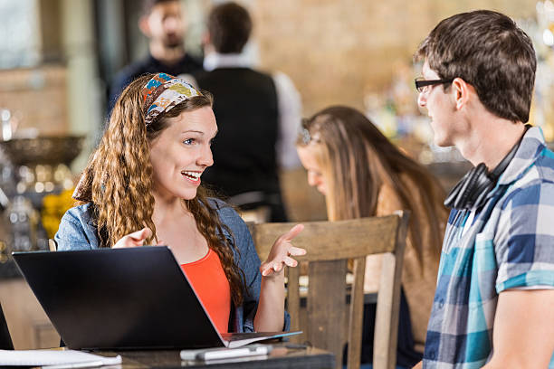 istock College friends using laptop during study date in coffee shop 480849287