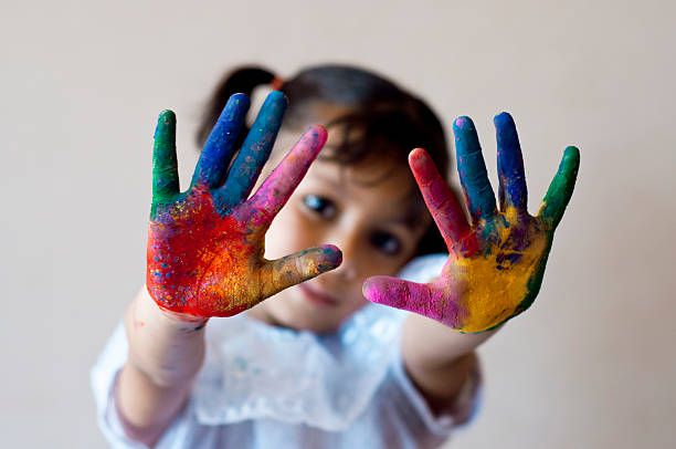 istock Girl showing colorful painted hands 480849695