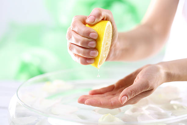 Lemon juice, natural cosmetics The woman squeezed the palm lemon juice physical description foods and drinks event household equipment stock pictures, royalty-free photos & images