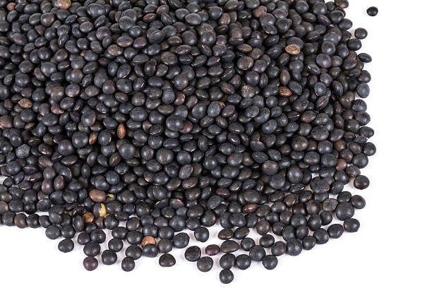 istock Heap of black lentil isolated on white 480856221