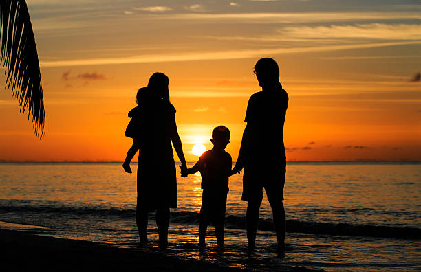 istock happy family with two kids on sunset beach 480858082