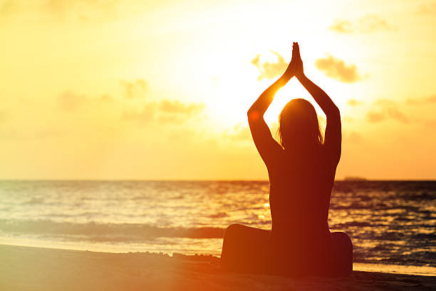 istock Woman meditation on the beach 480858920