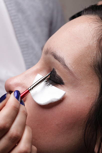 istock Woman applying eyeshadow makeup brush 480859107