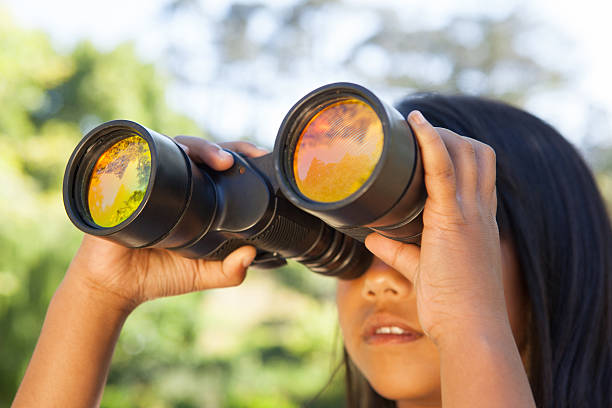 istock Cute little girl looking through binoculars 480860534