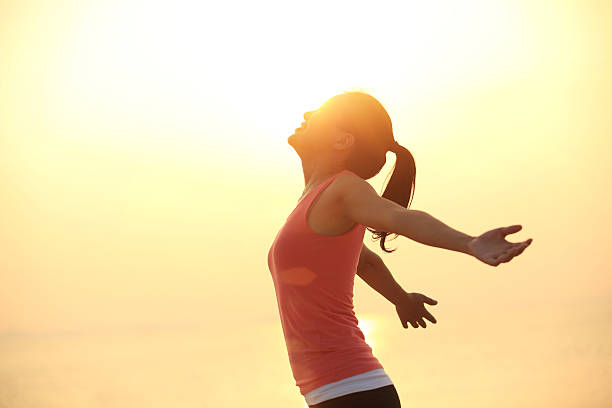 istock cheering woman open arms  at sunrise beach 480862533